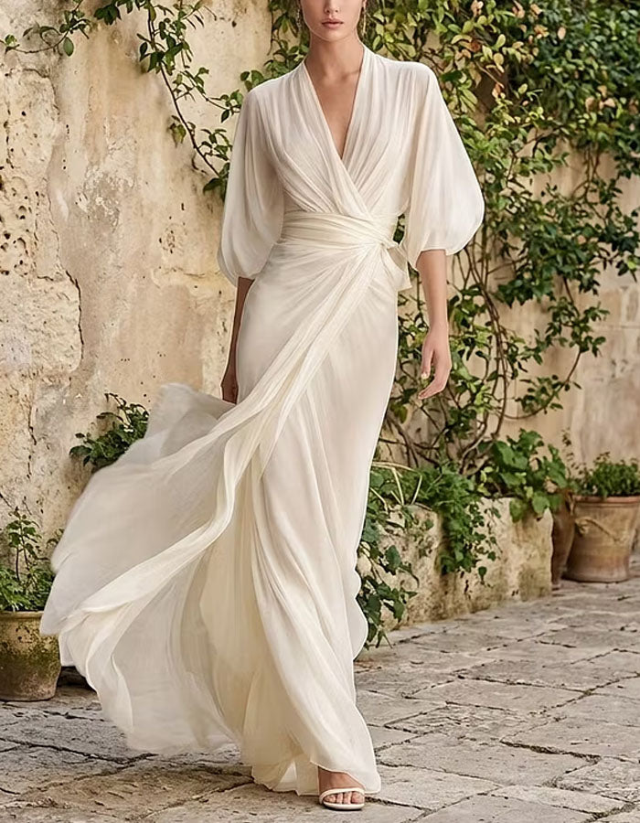 Vestido largo blanco de gasa con escote en V, mangas abullonadas y abertura