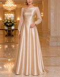 Vestido largo de satén champán con mangas de farol transparentes y cuello barco