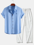 Short-sleeve button-up shirt in a linen-look fabric, and straight trousers with a crinkled texture