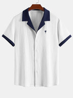 Wrinkled shirt with contrasting palm tree embroidery