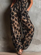 Loose-fitting animal print halter neck jumpsuit in black, with a wide leg