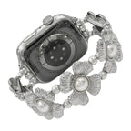 Correa elástica Apple Watch para mujer, con flores metálicas y perlas nacaradas, elegante accesorio de muñeca, modelo Sumeria