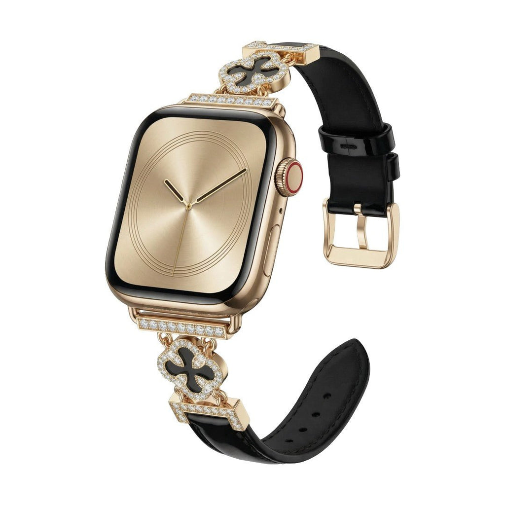 Correa Apple Watch para mujer en material sintético charolado, motivo trébol pavé de circonitas, aleación dorada elegante, modelo Circé