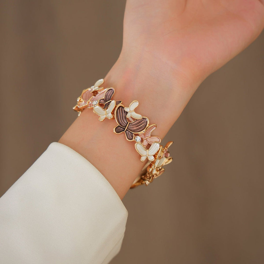 Correa Apple Watch con motivo de mariposas esmaltadas, malla elástica con strass, modelo Marjorie