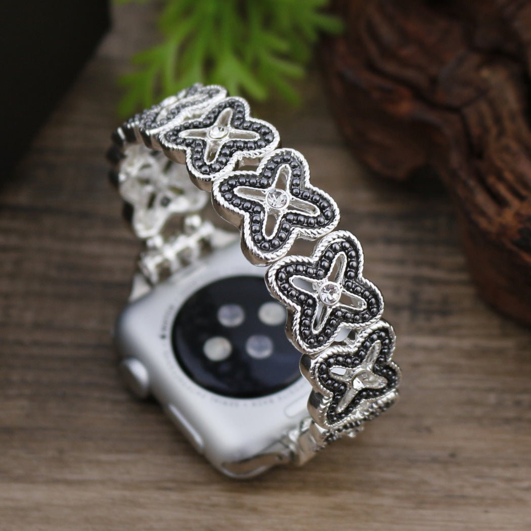 Correa Apple Watch de malla floral calada, pedrería y acabado bicolor, modelo Harpie