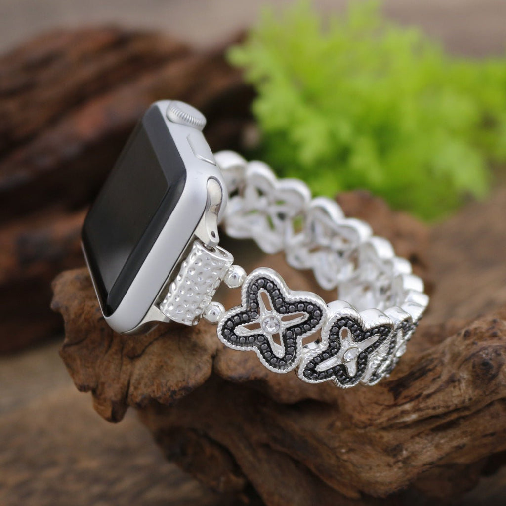 Correa Apple Watch de malla floral calada, pedrería y acabado bicolor, modelo Harpie