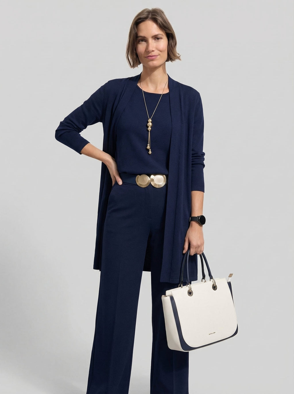 Conjunto cárdigan largo, top y pantalón de punto