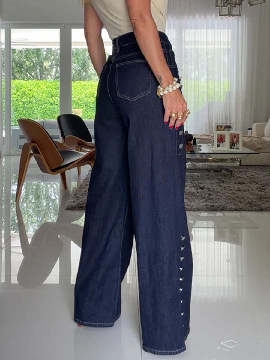 High-waisted wide-leg jeans with silver buttons and contrast stitching