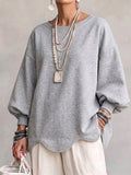 Oversized sweatshirt med vågig nederkant och puffärmar